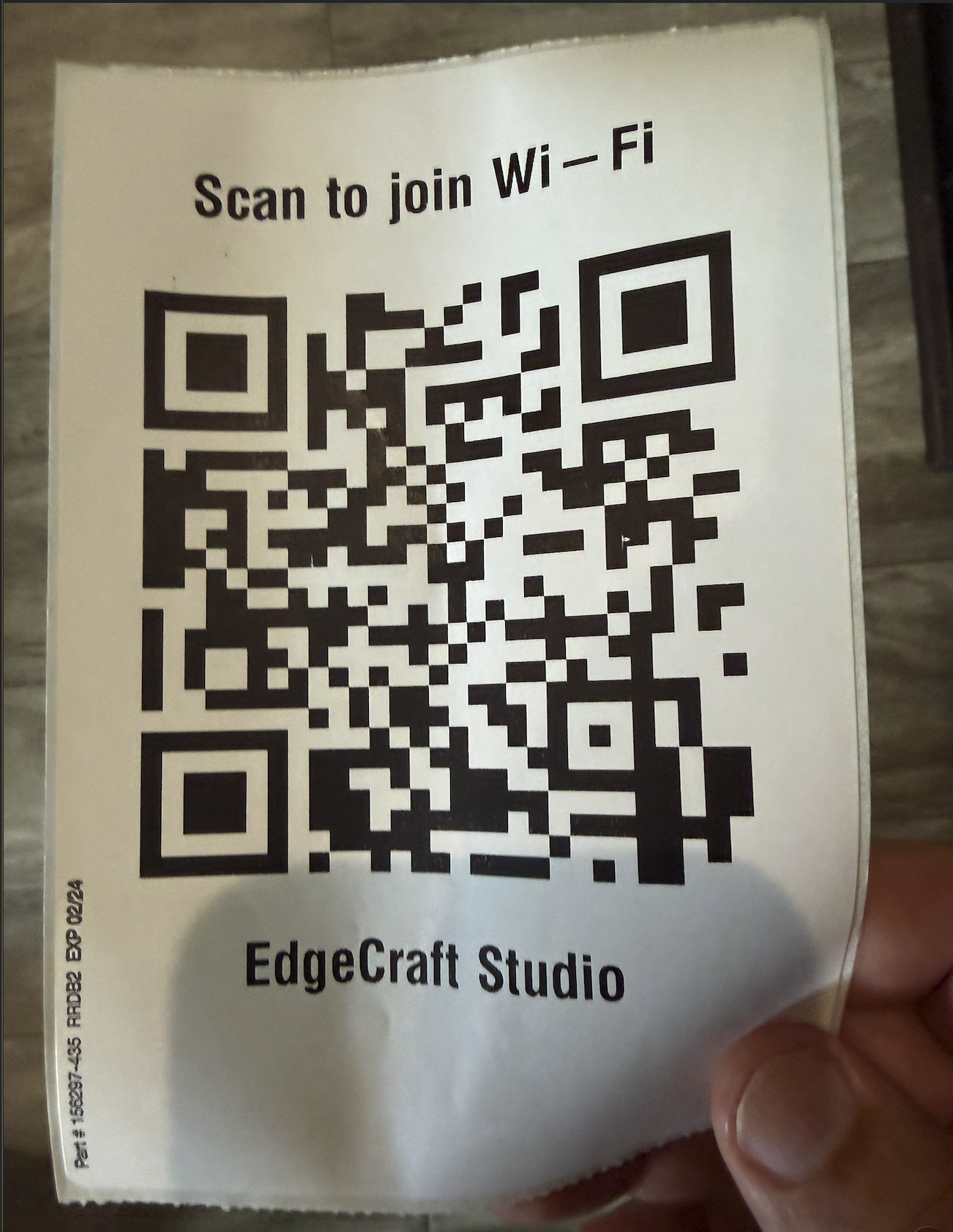 A 4x6 label fresh off a Zebra printer reading "Scan to join Wi-Fi" above a large QR code, with "EdgeCraft Studio" printed underneath